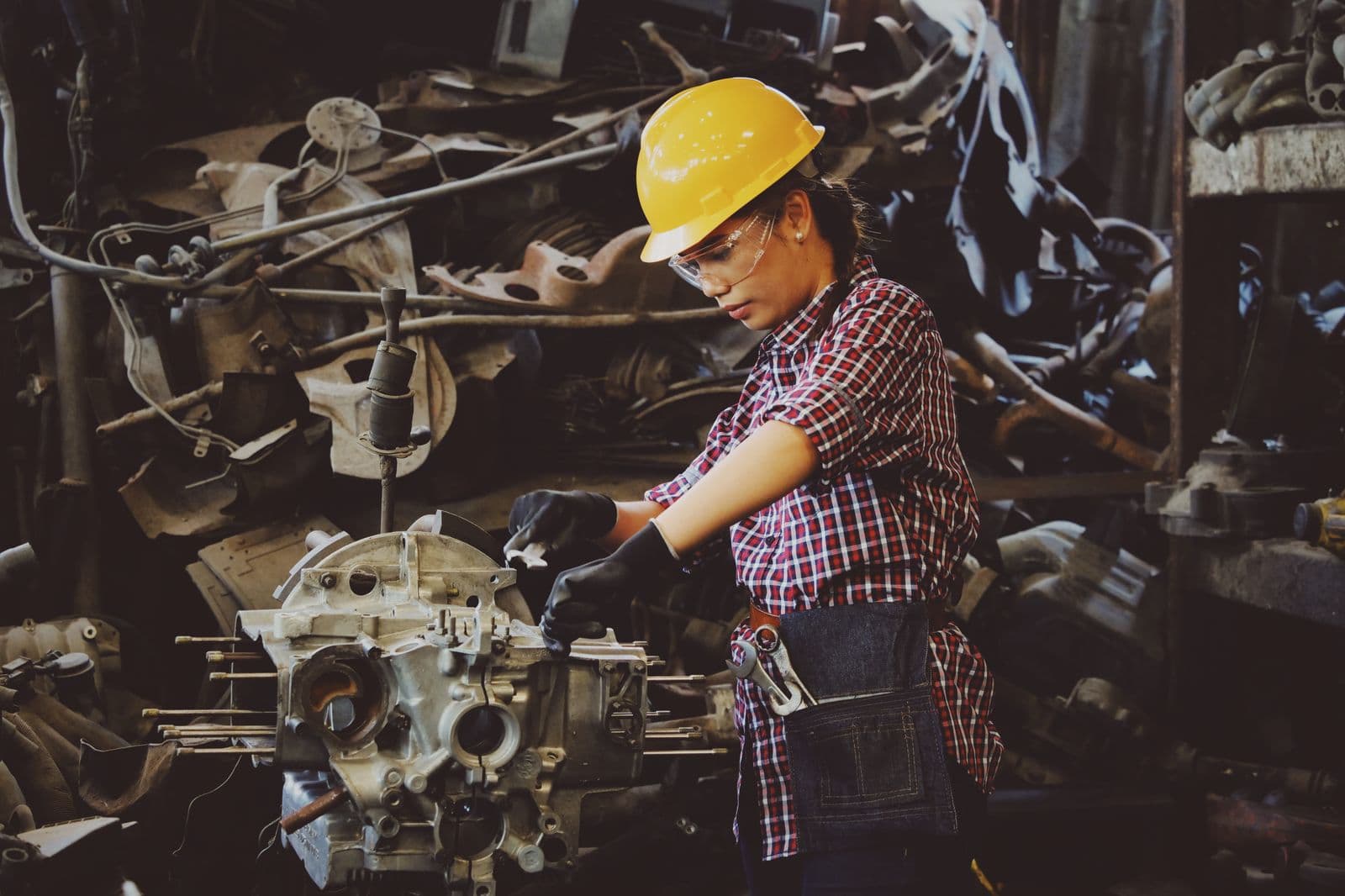 Technician inspecting a mechanical assembly in a workshop