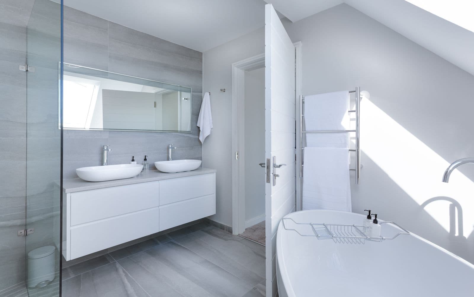 Spa bathroom with a stone bath set on river pebbles