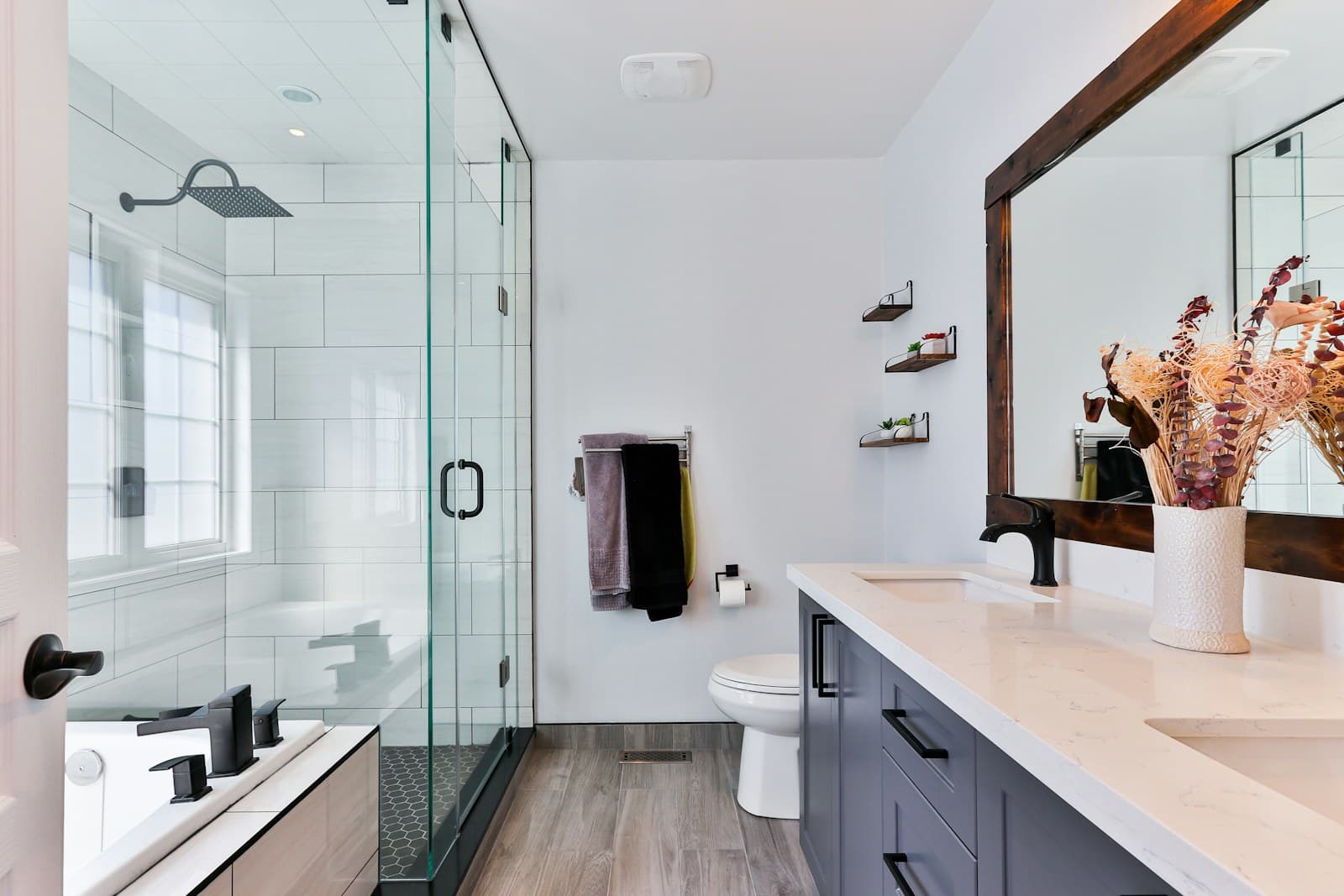 Contemporary bathroom with matte-black fittings and a glass wet room