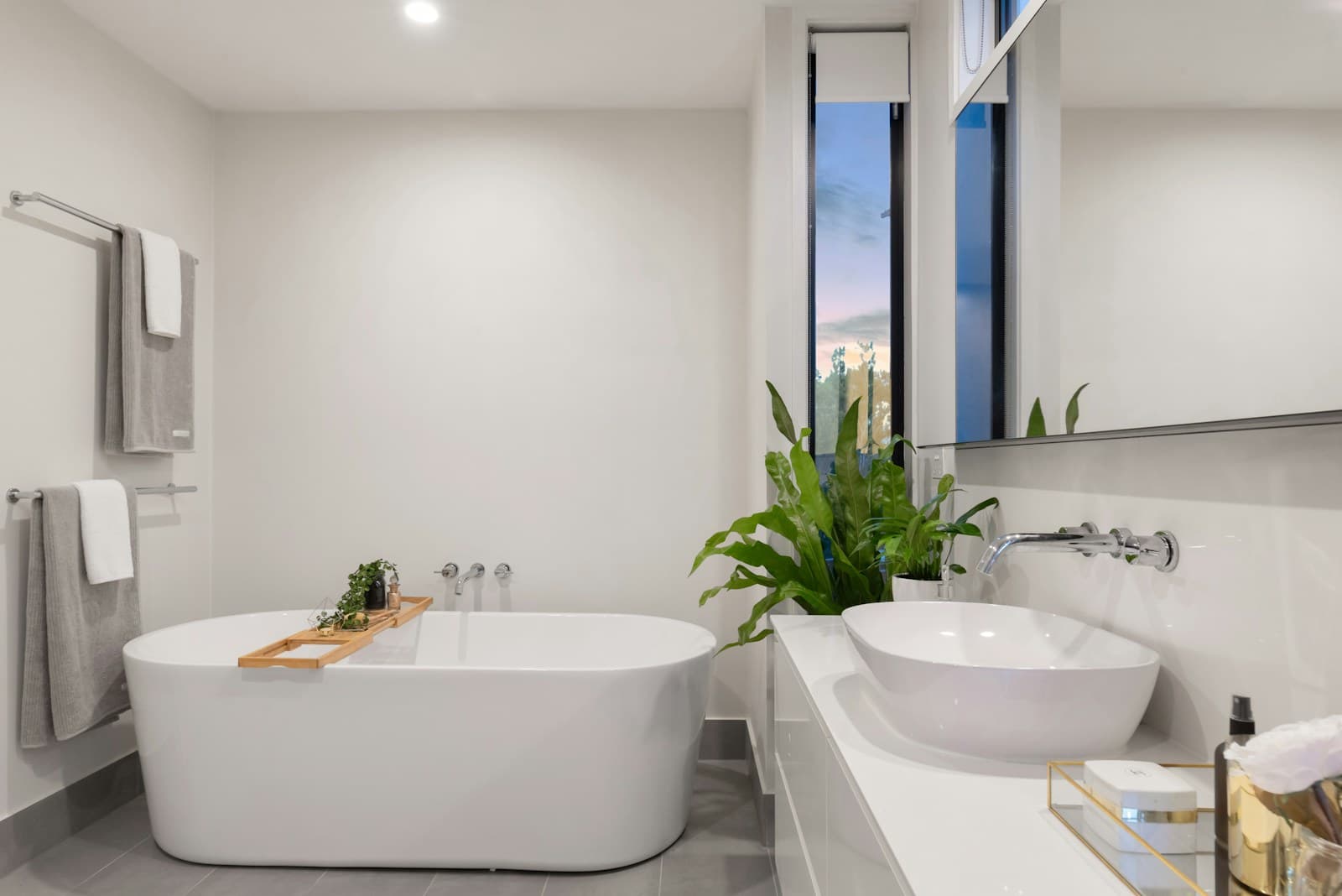 Walk-in bathroom with a freestanding bath and chrome rails